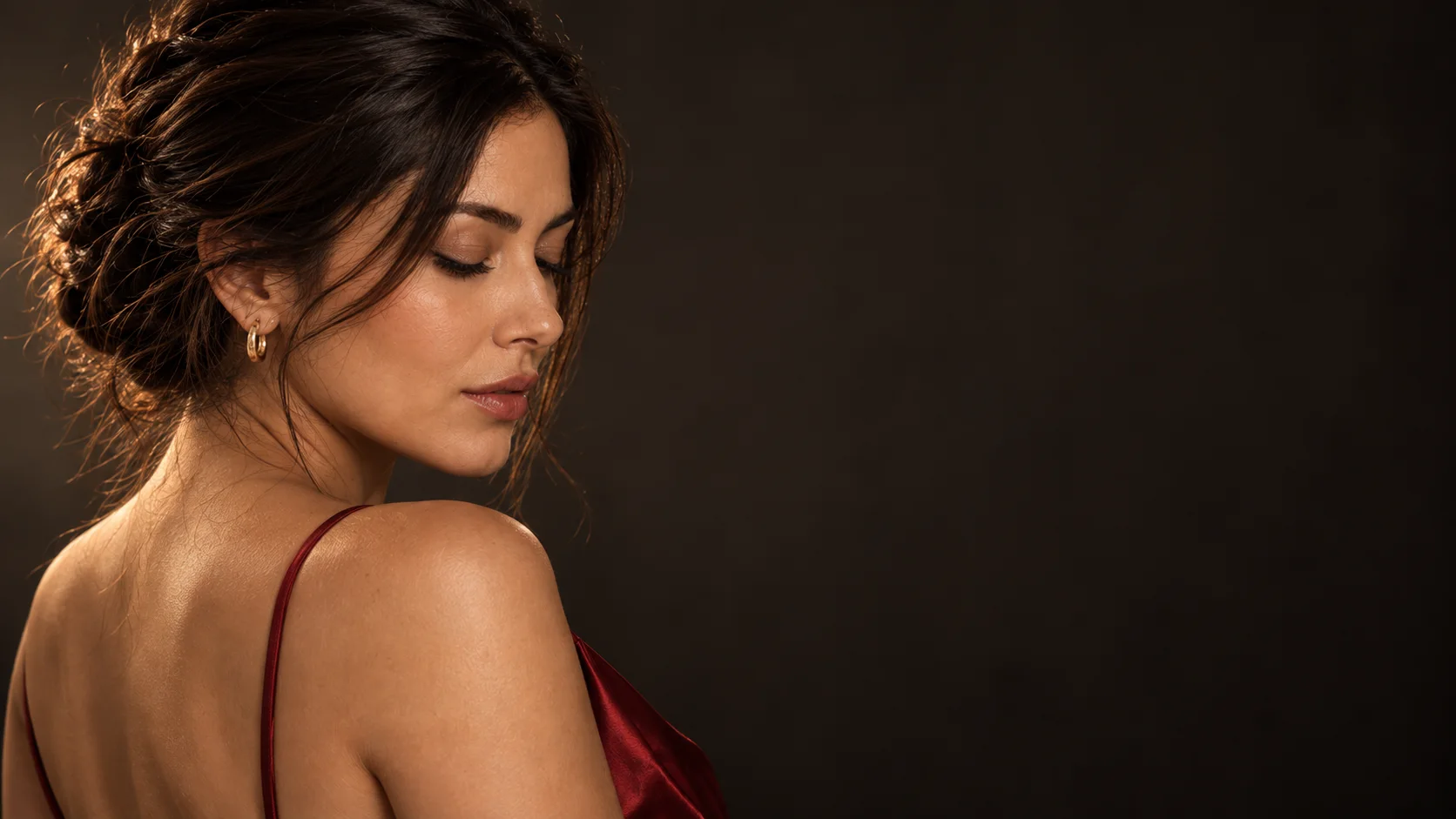 Sofia in profile, eyes closed, a red satin strap on her shoulder