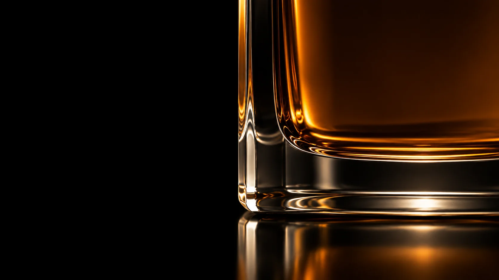 Macro of the heavy glass base, amber light breaking through it